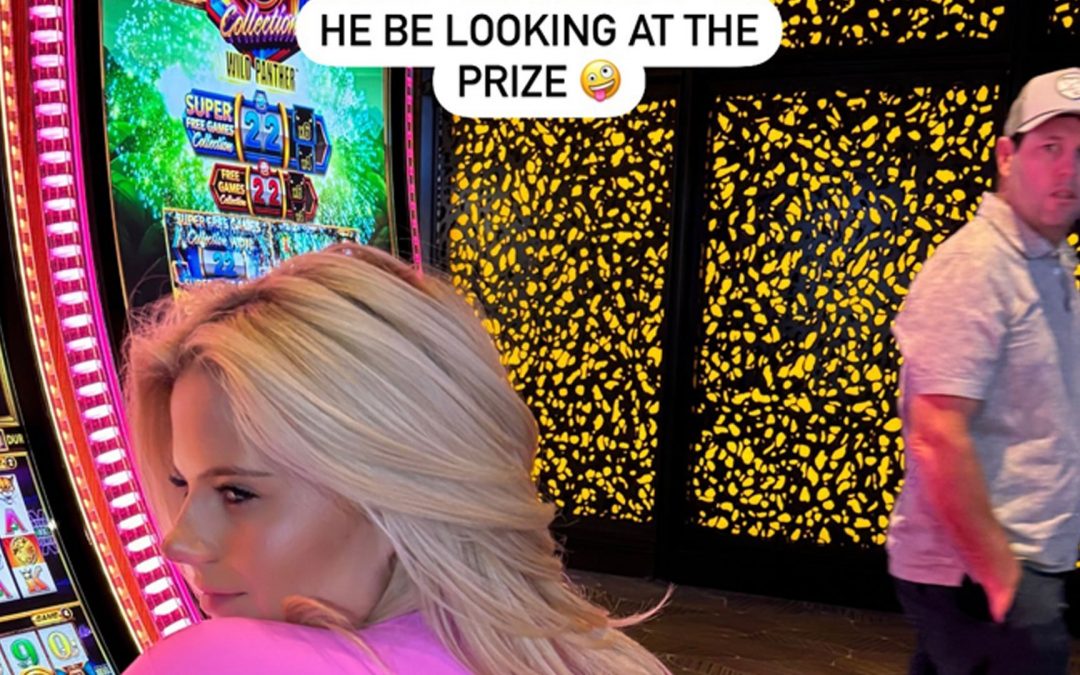 Boxing ring girl Apollonia Llewellyn ogled by passer-by as she wears busty outfit on slot machine in Vegas